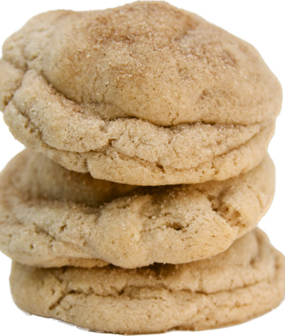 A stack of three soft and chewy snickerdoodle cookies with a generous dusting of cinnamon sugar on top