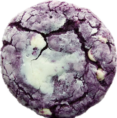 A close-up of a single ube crinkle cookie from Bake the Cookie Shoppe, dusted with powdered sugar