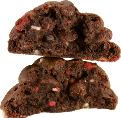 A chocolate peppermint chip cookie opened up to reveal layers of gooey chocolate and crunchy andes peppermint chips inside. The perfect indulgence for the holiday season.
