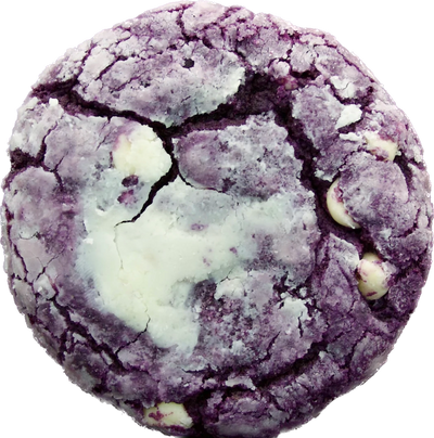 A close-up of a single ube crinkle cookie from Bake the Cookie Shoppe, dusted with powdered sugar